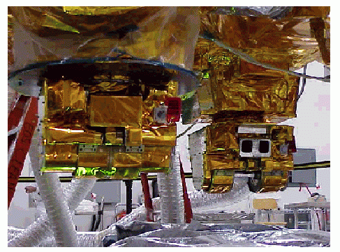 CERES instruments mounted on the Terra spacecraft during integration and testing. Image shows instruments with main and mam contamination covers in their closed and opened positions.