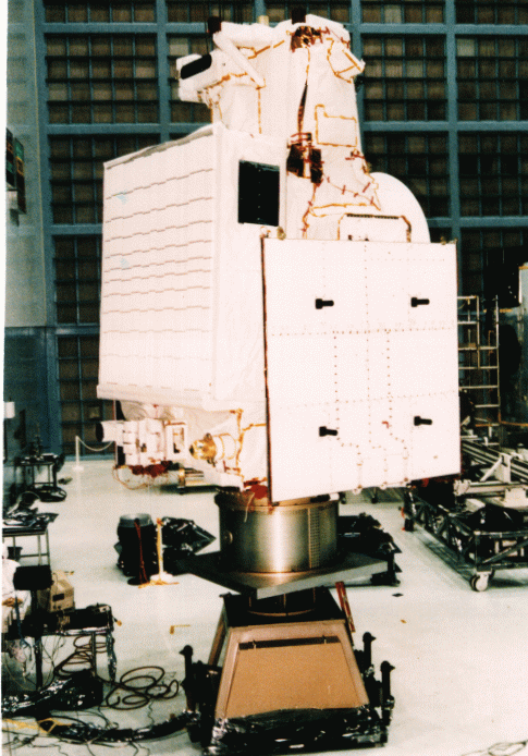Side view of TRMM spacecraft. The left side shows the large precipitation radar instrument, with LIS, CERES and ES scanners clearly seen at the bottom. The right side is again an undeployed solar panel.